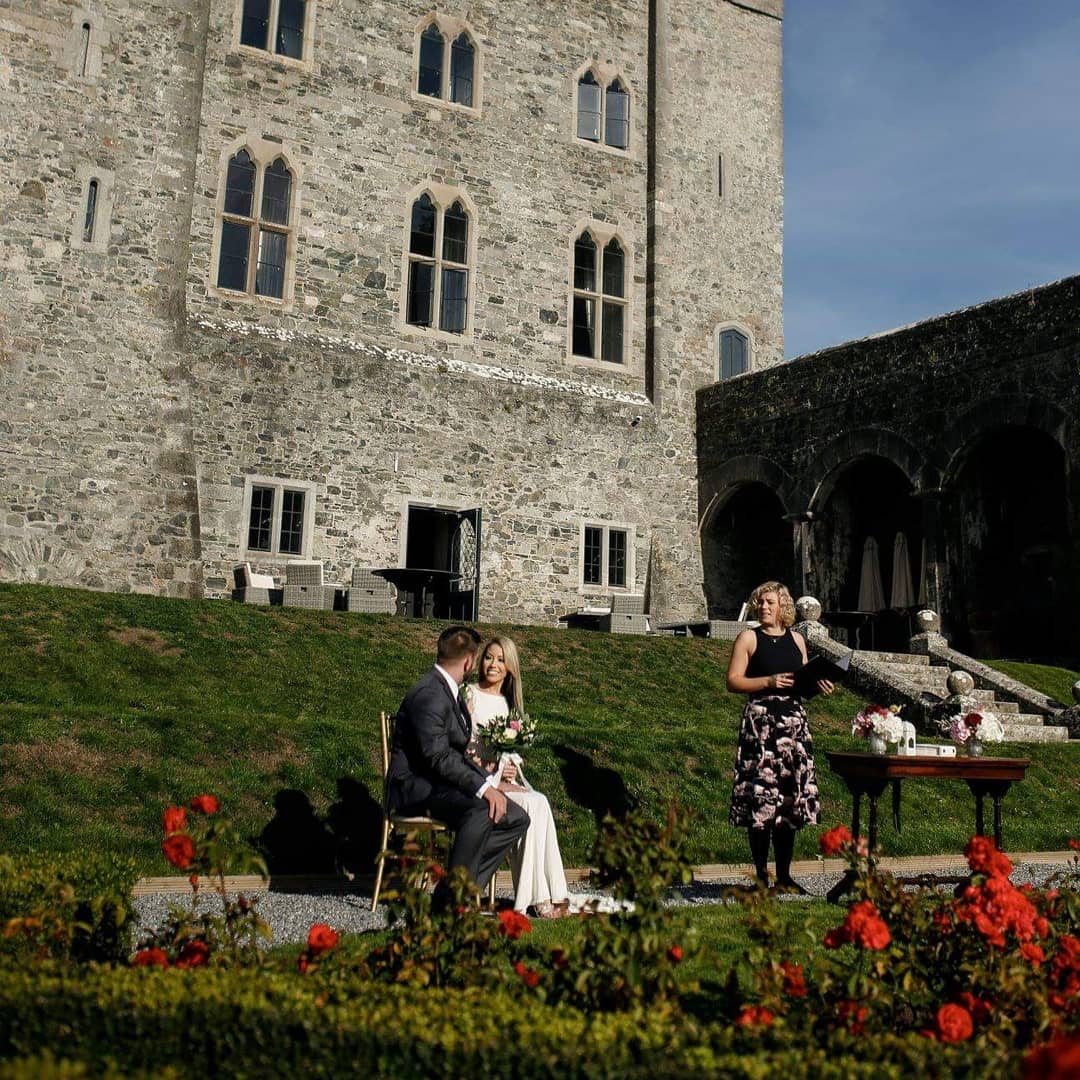 An intimate wedding ceremony on the lawn of a historic Irish castle