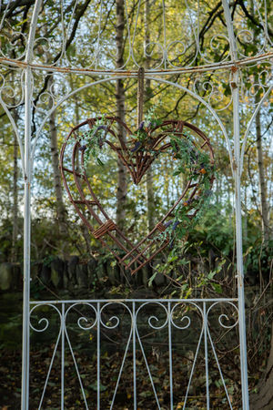 A woven heart wreath on the garden gate at Woodside Chapel