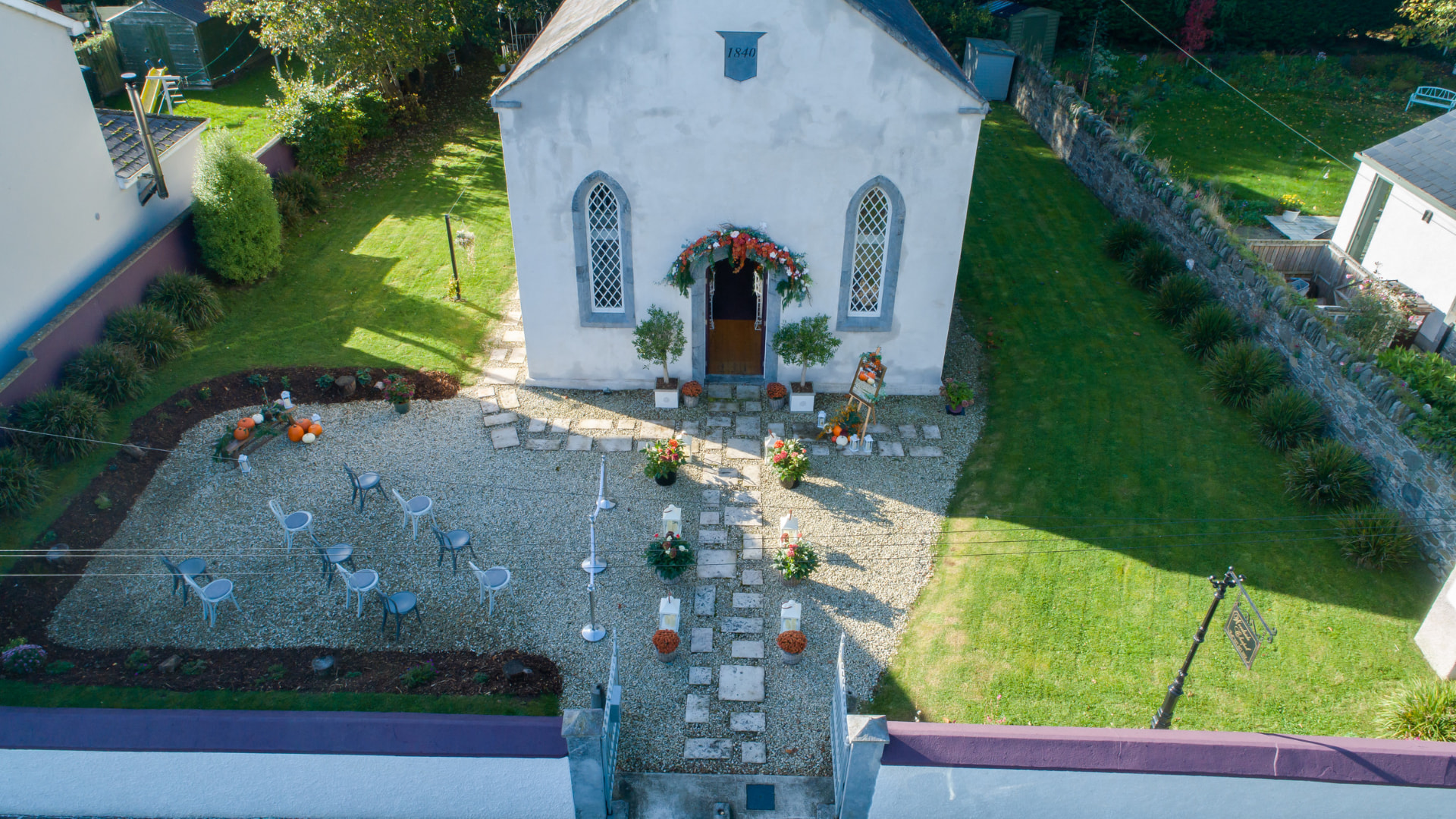 Aerial view of Woodside Chapel with ceremony chairs arranged in the garden